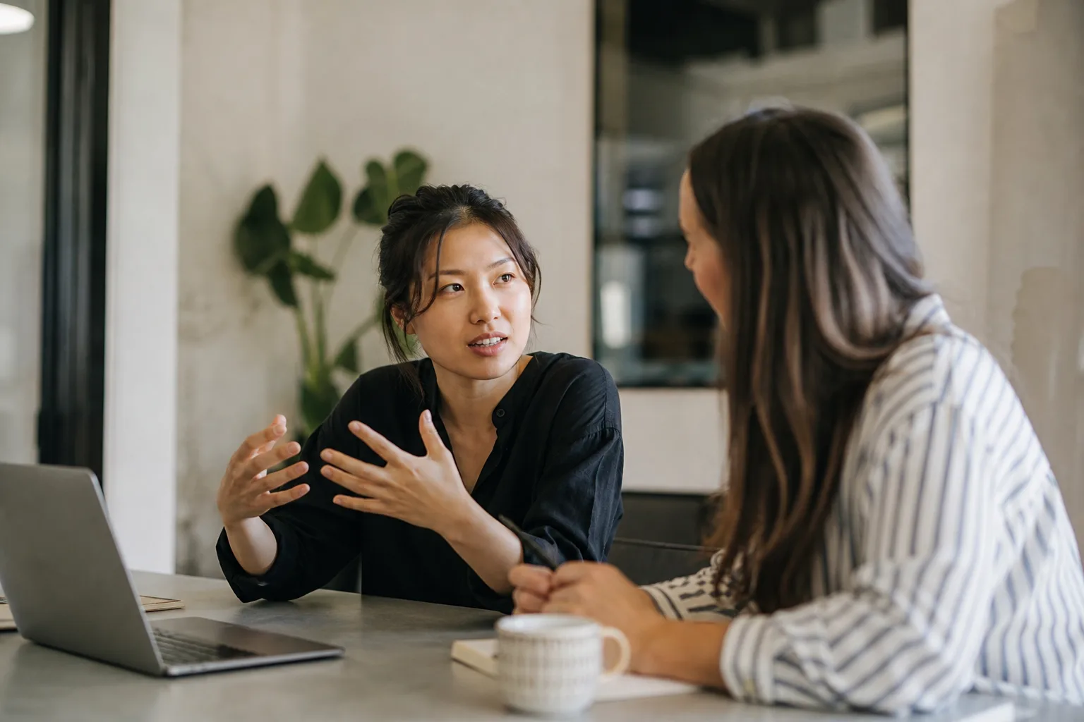 selective focus photography of people sits in front of table inside room