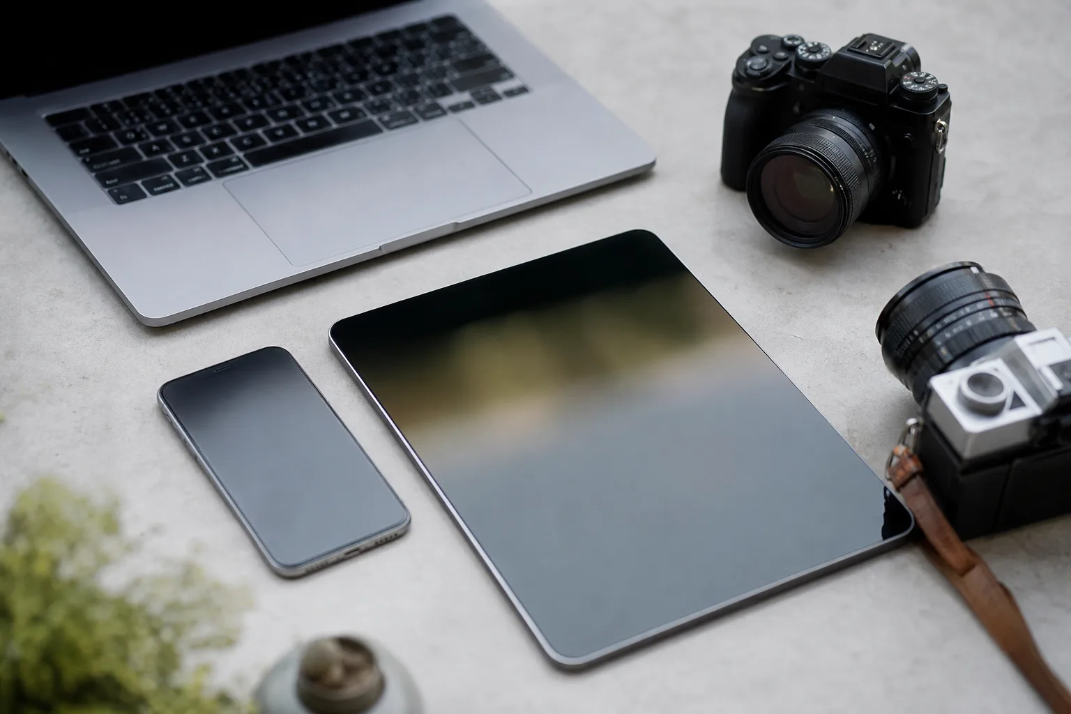 flat view of cameras beside computer tablet and smartphone
