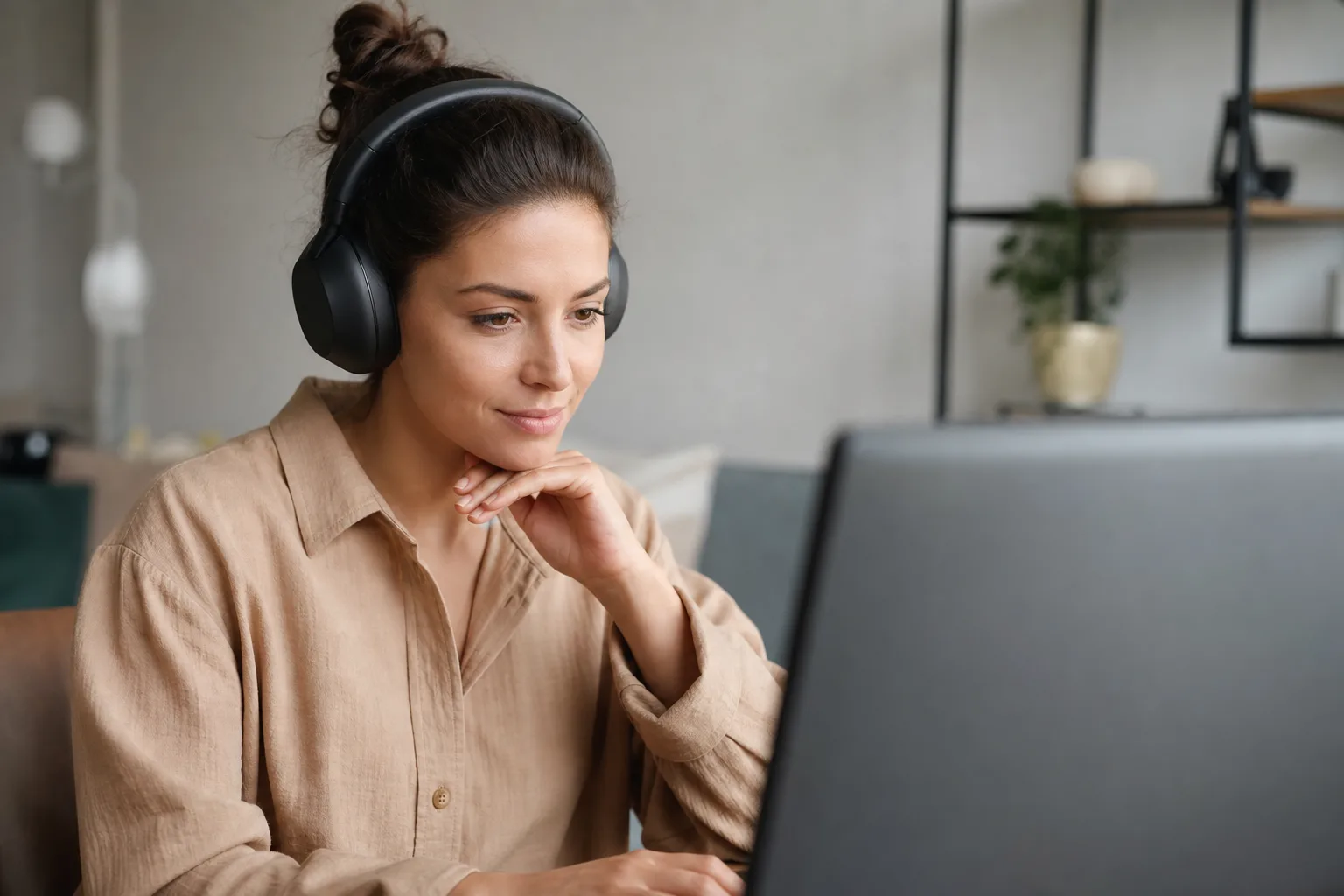 a person wearing headphones sitting in front of a computer