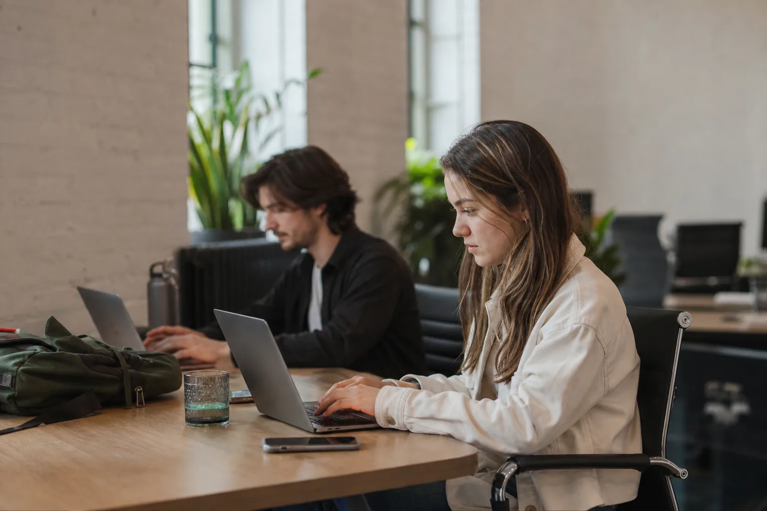 people sitting on chair in front of laptop computers