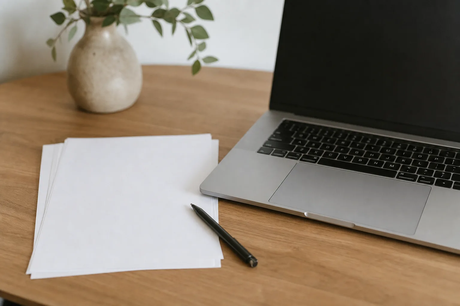 white printer paper beside silver laptop computer